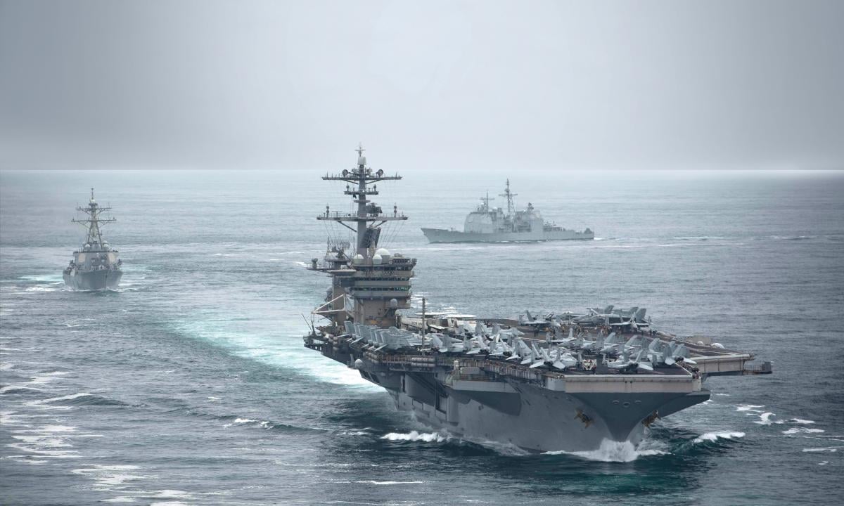 The aircraft carrier USS Theodore Roosevelt (CVN-71), USS Russell (DDG-59), and the USS Bunker Hill (CG-52), transit in formation.
