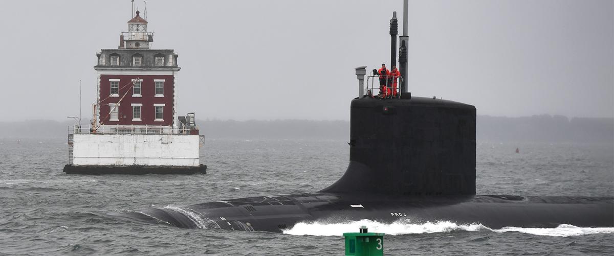 The Virginia-class fast-attack submarine USS Oregon (SSN-793) passes the New London Ledge Lighthouse during routine operations in the mouth of the Thames River in Groton, Connecticut.