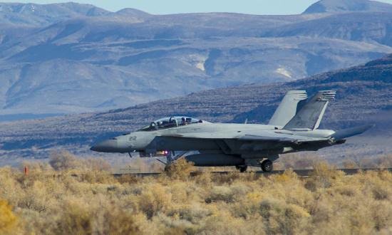 An F/A-18F assigned to Fighter Attack Squadron (VFA) 213 lands at Van Voorhis Airfield at Naval Air Station Fallon, Nevada, during the final phase of carrier air wing training before deploying. Aviation squadron intelligence officers and enlisted intelligence specialists often arrive at the month-long Fallon training phase with little in-depth knowledge of the adversary, the platform they support, or the mission-planning process.