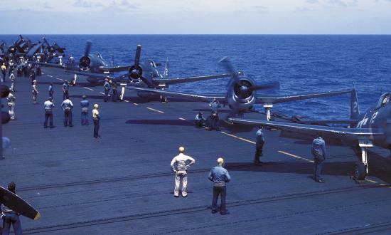 F6F Hellcats warm up on the flight deck of the USS Cowpens in early 1944. From 1943 on, she would fight in nearly every carrier battle until the end of the war and garner 12 battle stars—the most of any of the Independence-class light carriers.